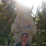 Brian K. man standing in front of a bear statue